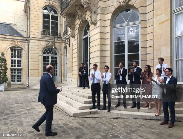France's Prime Minister Jean Castex is applauded by collaborators at the Matignon Hotel on his way back from the Elysee presidential palace where he...