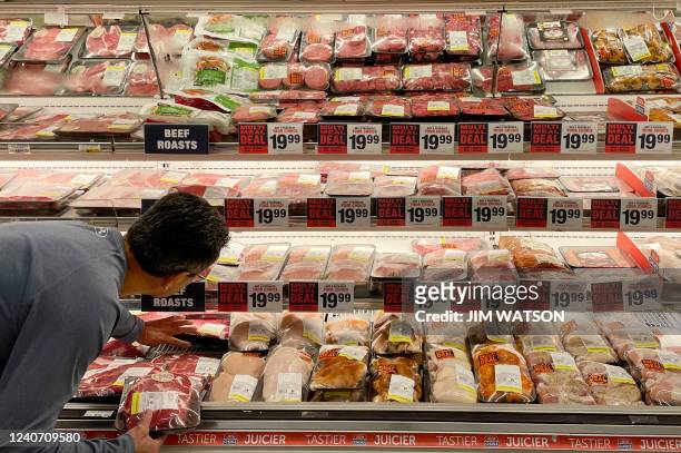 Man shops for meat at a Safeway grocery store in Annapolis, Maryland, on May 16 as Americans brace for summer sticker shock as inflation continues to...