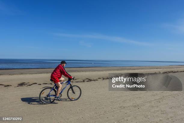 Man cycling at the beach is seen in Jurmala , Latvia on 5 May 2022 Jurmala is a resort town about 25 km west of Riga, sandwiched between the Gulf of...
