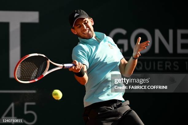 Austria's Dominic Thiem returns a ball to Italia's Marco Cecchinato during their match at the ATP 250 Geneva Open tennis tournament in Geneva on May...