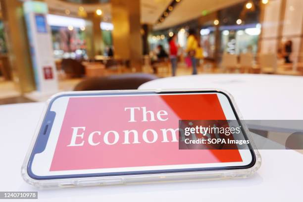 In this photo illustration, The Economist logo is displayed on a smartphone screen.