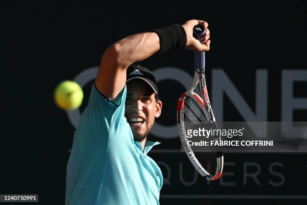 Austria's Dominic Thiem returns a ball to Italy's Marco Cecchinato during their match at the ATP 250 Geneva Open tennis tournament in Geneva on May...