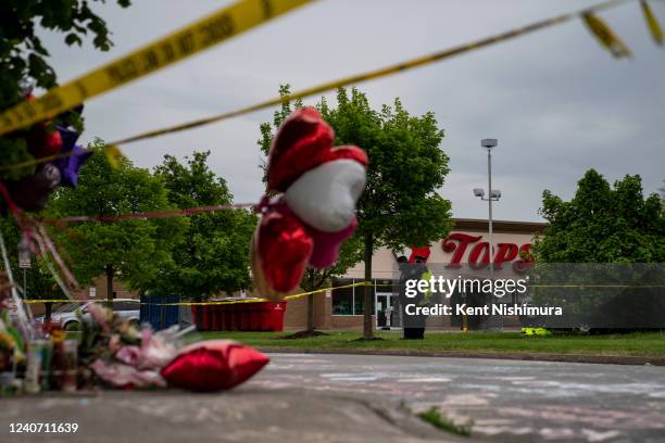 People gather at the scene of a mass shooting at Tops Friendly Market at Jefferson Avenue and Riley Street on Monday, May 16, 2022 in Buffalo, NY....
