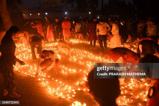 Buddhist devotees light oil lamps at the Mayadevi temple on the occasion of Buddha Purnima, which marks Gautama Buddha's birth anniversary, in...