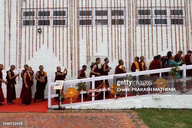 Buddhist monks arrive to offer prayers at the Mayadevi temple on the occasion of Buddha Purnima, which marks Gautama Buddha's birth anniversary, in...