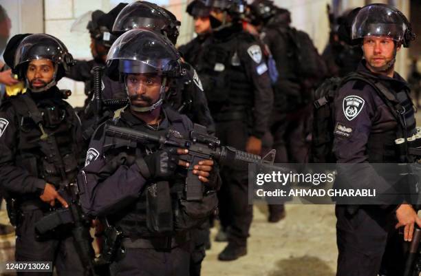 Israeli security forces stand guard as they clash with Palestinians following the funeral of Walid al-Sharif who died of wounds suffered last month...