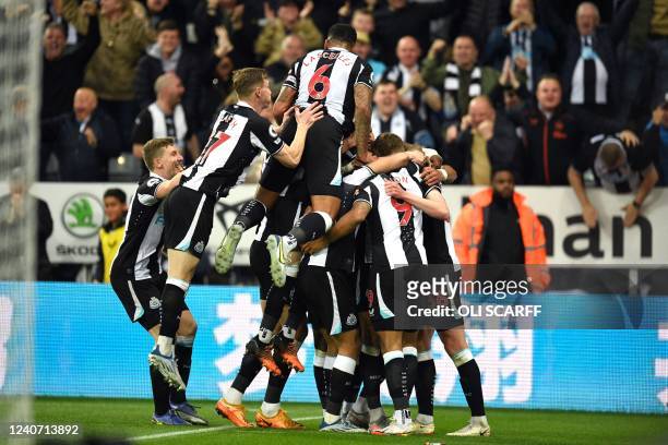 Newcastle United's English striker Callum Wilson is mobbed by teammates after scoring the opening goal during the English Premier League football...