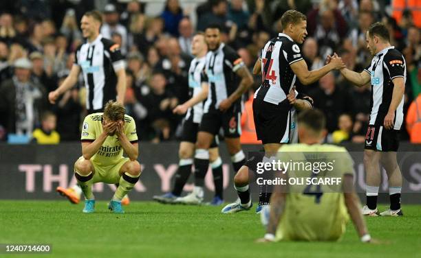 Arsenal's Norwegian midfielder Martin Odegaard and Arsenal's English defender Ben White react after the English Premier League football match between...