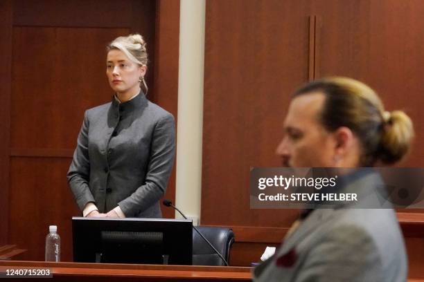 Actors Amber Heard and Johnny Depp watch as the jury leaves the courtroom at the end of the day at the Fairfax County Circuit Courthouse in Fairfax,...