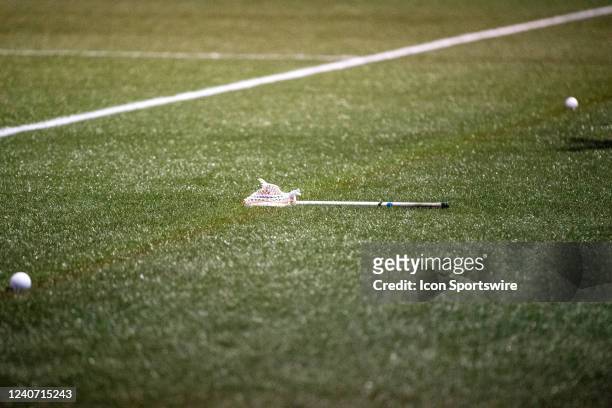 Broken lacrosse stick lies on the sideline during the NCAA Division I Men's Lacrosse Tournament First Round game between the Virginia Cavaliers and...