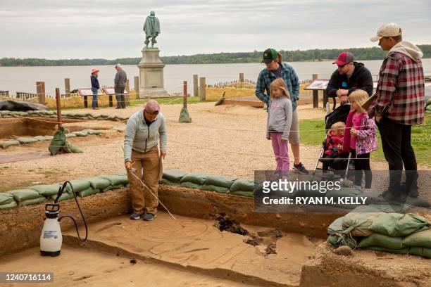 Caitlin Delmas, staff archaeologist, discusses her work with visitors at Jamestown, Virginia, on May 10, 2022. - Water arrived overnight and...