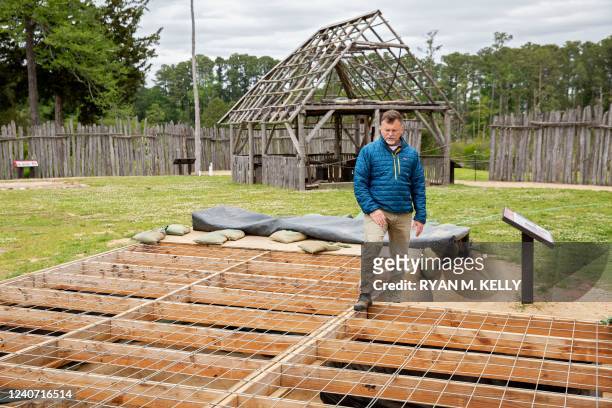 David Givens, director of archaeology, stands over a dig site at Jamestown, Virginia, on May 10, 2022. - Water arrived overnight and submerged an...