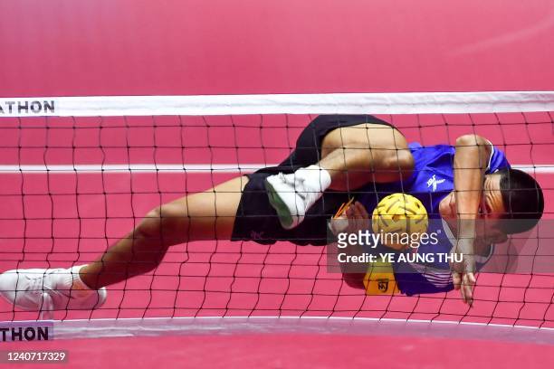 Laos' Laksanaxay Bounphaivanh kicks the ball during the sepak takraw men's match against Indonesia at the 31st Southeast Asian Games in Hanoi on May...
