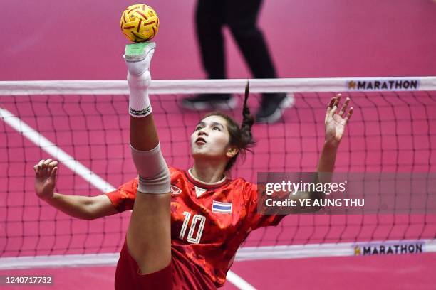 Thailand's Lac Somruedee Pruepruk balances the ball during the sepak takraw women's match against Malaysia at the 31st Southeast Asian Games in Hanoi...