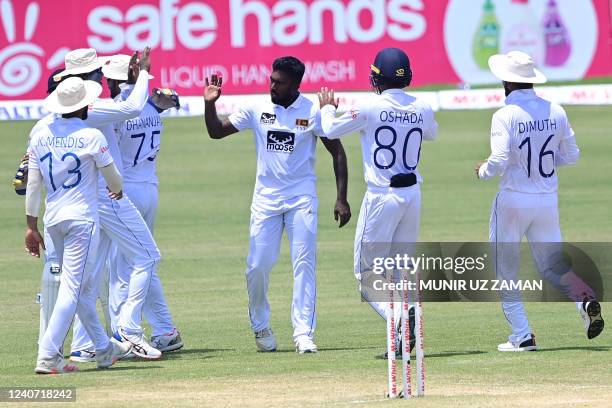 Sri Lanka's Asitha Fernando celebrates with teammates after taking the wicket of Bangladesh's Mahmudul Hasan Joy during the third day of the first...