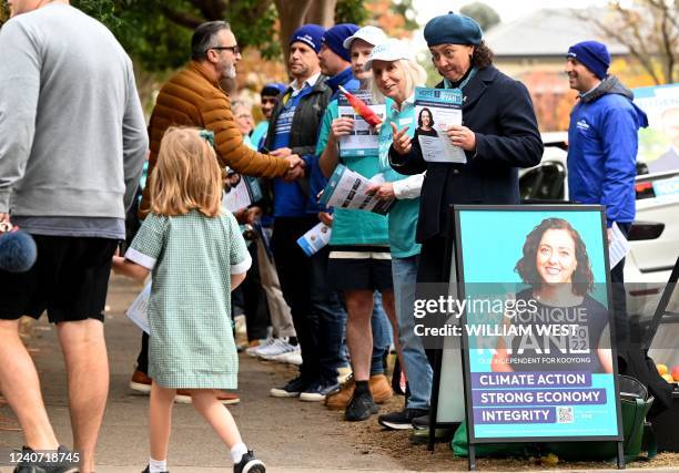 Independent candidate Monique Ryan greets voters at a pre-polling centre in Melbourne on May 17, 2022 as she takes on Australia's treasurer Josh...