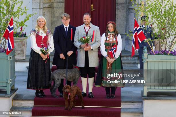 Crown Princess Mette-Marit, Prince Sverre Magnus, Crown Prince Haakon and Princess Ingrid Alexandra and their dogs stand at their residence Skaugum...