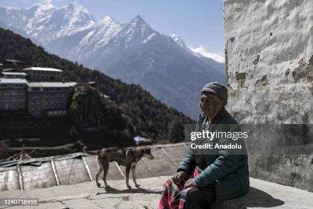 An old sherpa woman in front of her house at Namche Bazar in Lukla, Nepal on April 21, 2022. Rising food and energy prices have lowered Nepal's...
