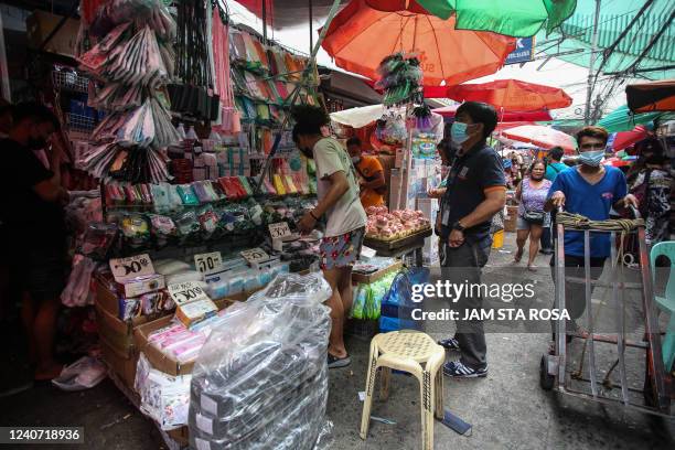 Man shops for face masks in Divisoria, a local shopping district in Manila on May 17, 2022.