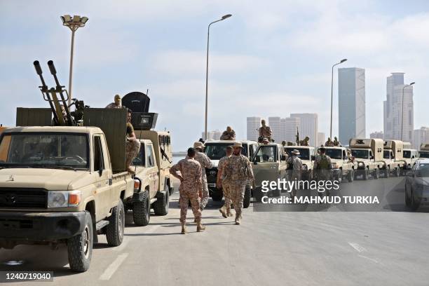 Vehicles of forces loyal to Libya's Tripoli-based Prime Minister Abdulhamid Dbeibah are parked along the waterfront in the capital Tripoli on May 17,...