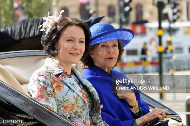 Mrs Jenni Haukio wife of the President of the Republic of Finland and Sweden's Queen Silvia are pictured during a cortege in central Stockholm,...