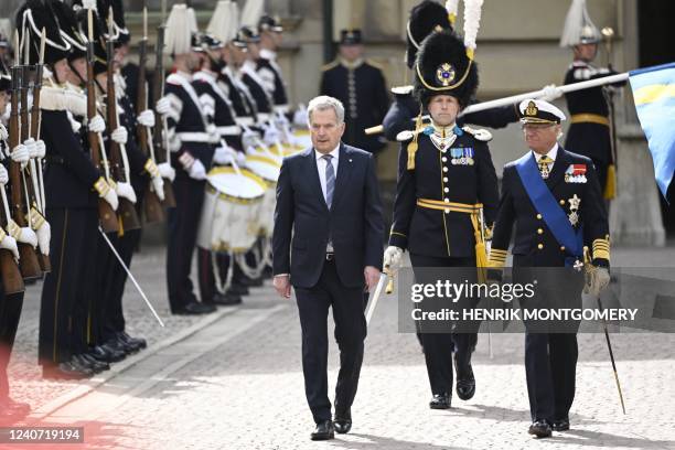 Finland's President Sauli Niinisto and Sweden's King Carl XVI Gustaf inspect an honory guard at the Royal Stables in Stockholm, Sweden, on May 17,...