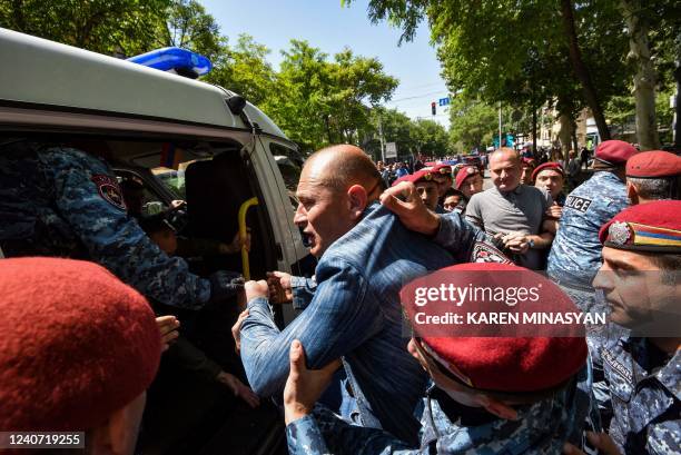 Police officers detain opposition supporters who attempted to block streets in the capital Yerevan on May 17, 2022. - Since mid-April, opposition...