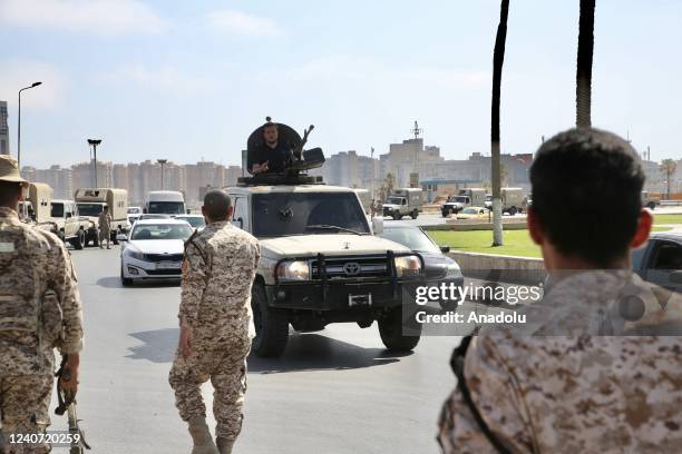 Vehicles of forces loyal to Libya's Tripoli-based Prime Minister Abdulhamid Dbeibeh are parked after forces of the rival Tobruk-based government...