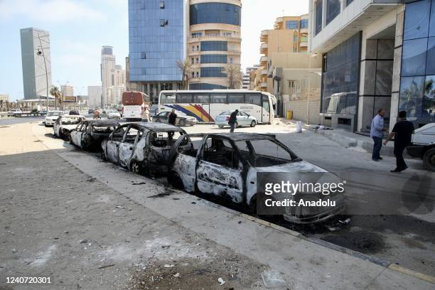 Damaged vehicles are seen as vehicles of forces loyal to Libya's Tripoli-based Prime Minister Abdulhamid Dbeibeh are parked after forces of the rival...