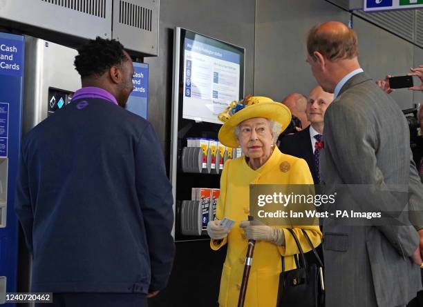 Queen Elizabeth II and the Earl of Wessex next to a ticket machine at Paddington station in London during a visit to mark the completion of London's...