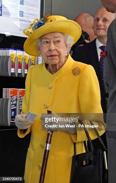 Queen Elizabeth II next to a ticket machine at Paddington station in London during a visit to mark the completion of London's Crossrail project....