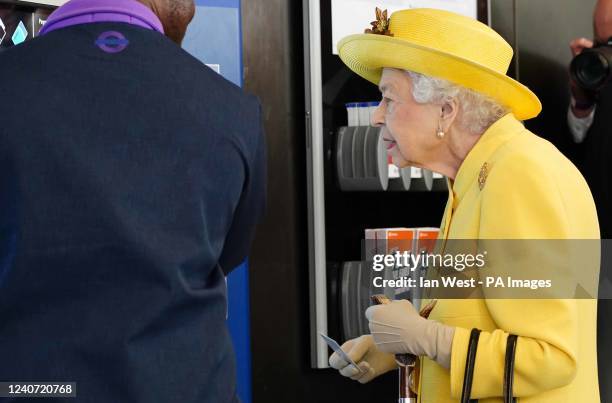 Queen Elizabeth II next to a ticket machine at Paddington station in London during a visit to mark the completion of London's Crossrail project....