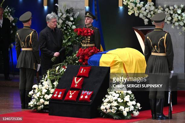 Former Ukrainian President Petro Poroshenko lays flowers next to the coffin during the funeral ceremony of former President of Ukraine Leonid...