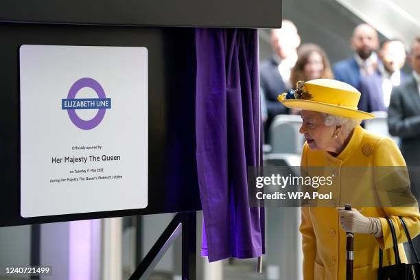 Queen Elizabeth II unveils a plaque to mark the Elizabeth line's official opening at Paddington Station on May 17, 2022 in London, England.