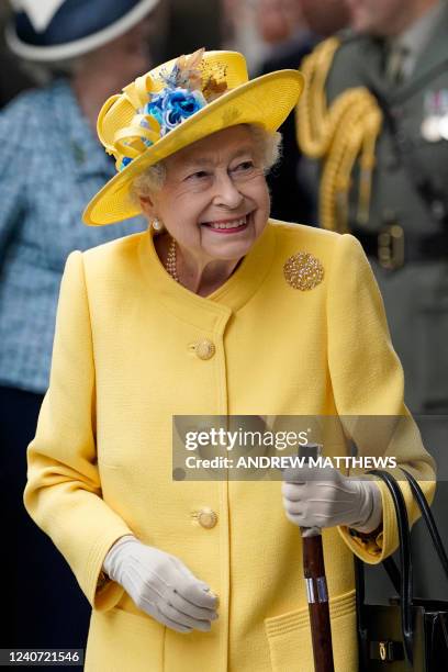 Britain's Queen Elizabeth II reacts during her visit to Paddington Station in London on May 17 to mark the completion of London's Crossrail project,...