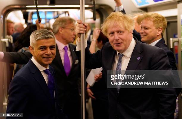 Mayor of London Sadiq Khan and Britain's Prime Minister Boris Johnson travel in a carriage of an 'Elizabeth Line' train during a visit to Paddington...