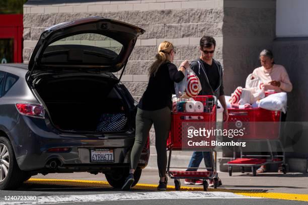 Customers loads items into the back of a car outside a Target store in Pleasant Hill, California, US, on Wednesday, May 11, 2022. Target Corp. Is...