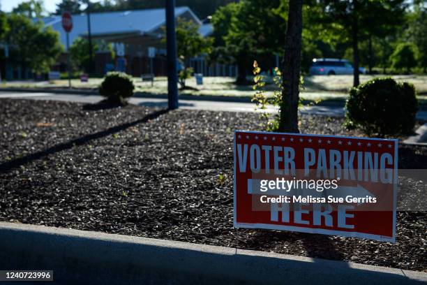 Signs direct voters outside a polling place on May 17, 2022 in Cary, North Carolina. A slow but steady stream of people began voting early Tuesday...
