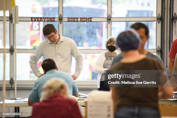 Voters receive their ballots at a fire station turned polling place on May 17, 2022 in Cary, North Carolina. A slow but steady stream of people began...