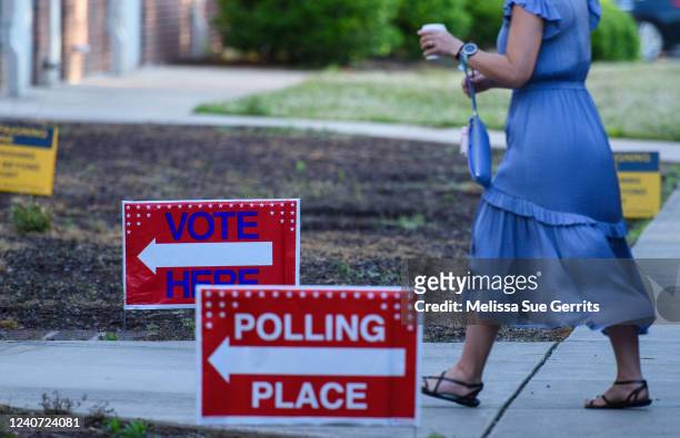 Woman walks into a polling place to cast her ballot on May 17, 2022 in Cary, North Carolina. A slow but steady stream of people began voting early...