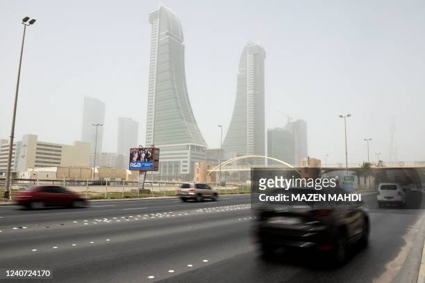 Cars drive on a highway in the Bahrain Financial Harbor area during a dust storm in the capital Manama, on May 17, 2022.