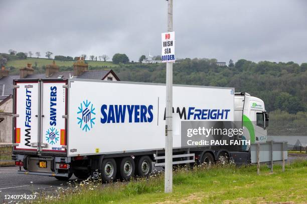 Lorry passes a 'No Irish Sea Border' sign as it is driven away from Larne port, north of Belfast in Northern Ireland, after arriving on a ferry, on...