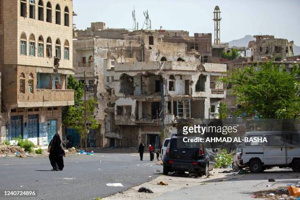 Yemenis walk in the rebel-besieged city of Taez on May 17, 2022.