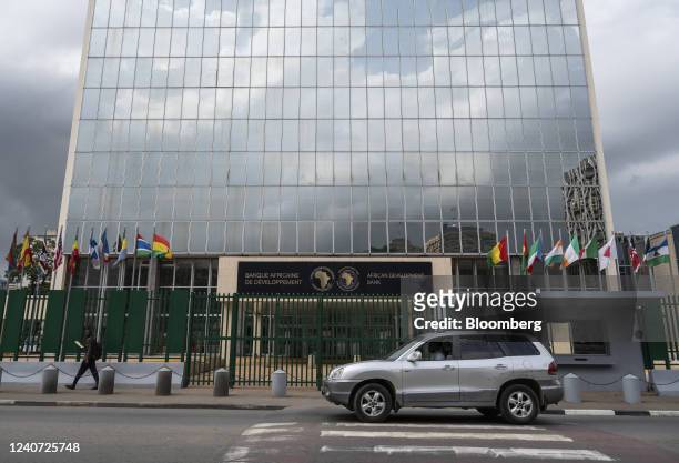 An automobile passes the headquarters for the African Development Bank in the Plateau business district of Abidjan, Ivory Coast, on Monday, May 16,...
