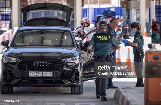 Members of the Spanish Guardia Civil check travelers arriving from Morocco to the border crossing in the Spanish enclave of Ceuta, on May 17, 2022. -...
