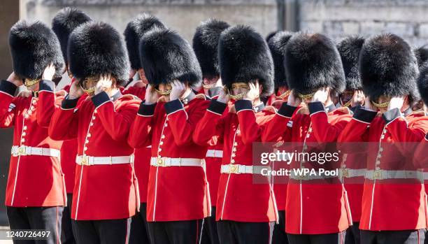 Guardsmen of the 1st battalion Irish guards prepare to remove their ceremonial bearskin hats during the parade in the Quadrangle of Windsor Castle...