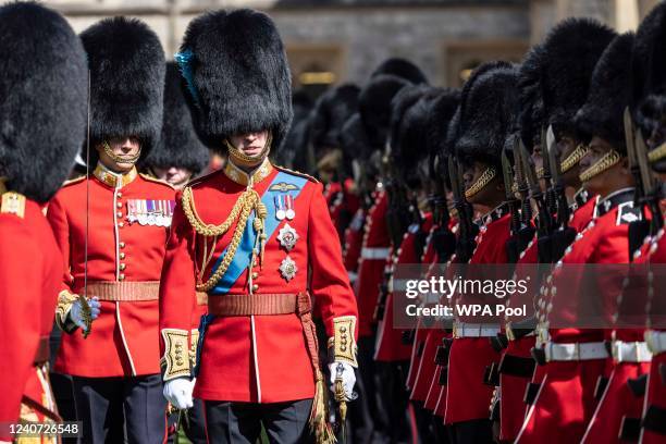 Prince William, The Duke of Cambridge, Colonel of the Irish Guards, inspects the 1st battalion in the Quadrangle of Windsor Castle before presenting...