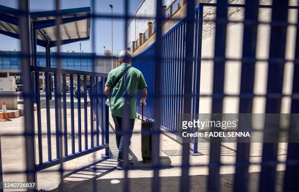 Travelers arrive to the border crossing in the Spanish enclave of Ceuta on their way to Morocco, on May 17, 2022. - Morocco and Spain have reopened...