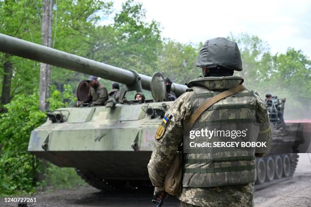 Ukrainian serviceman looks at a self-propelled howitzer on a road in Kharkiv region on May 17 amid Russian invasion of Ukraine.