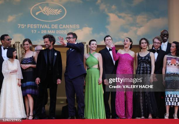 French film director and producer Michel Hazanavicius waves with cast members as they arrives to attend the screening of "Final Cut " ahead of the...